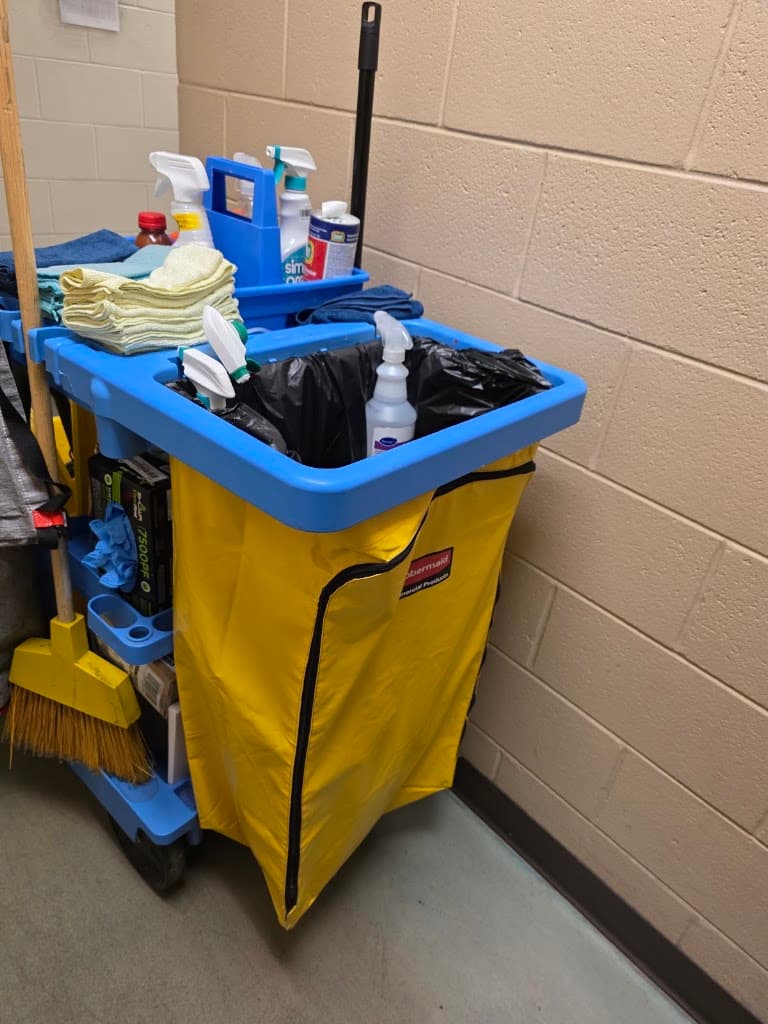 Fully stocked janitorial cart with cleaning supplies and equipment