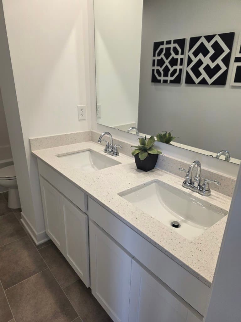 Spotless white double-sink bathroom vanity after a house cleaning